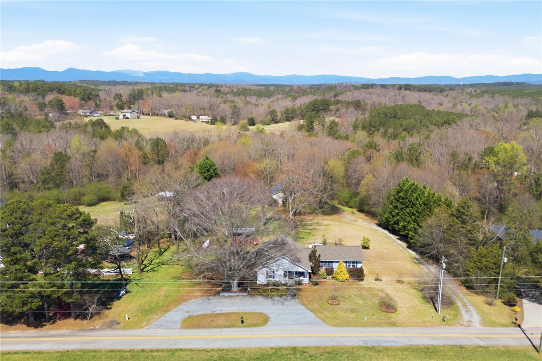 175 Burkett Road Seneca, SC 29672 - Photo 43 of 47 This elevated view captures a charming residence amidst rolling hills and lush woodlands.