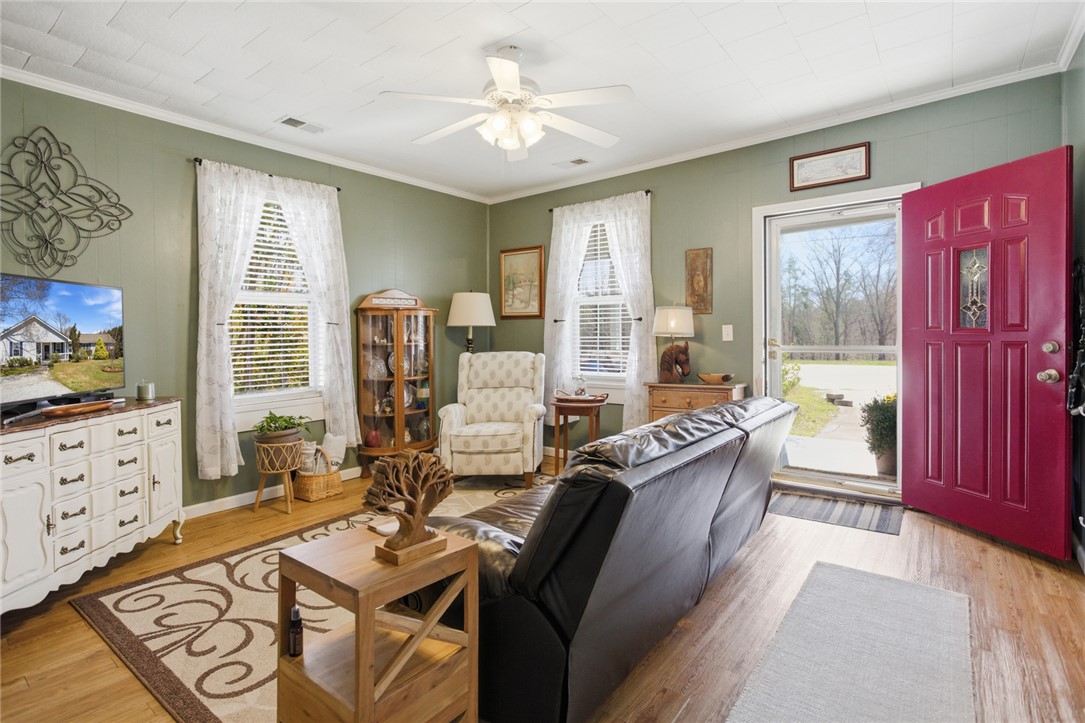 175 Burkett Road Seneca, SC 29672 - Photo 6 of 47 This inviting living space features warm flooring, abundant natural light, and classic architectural details.