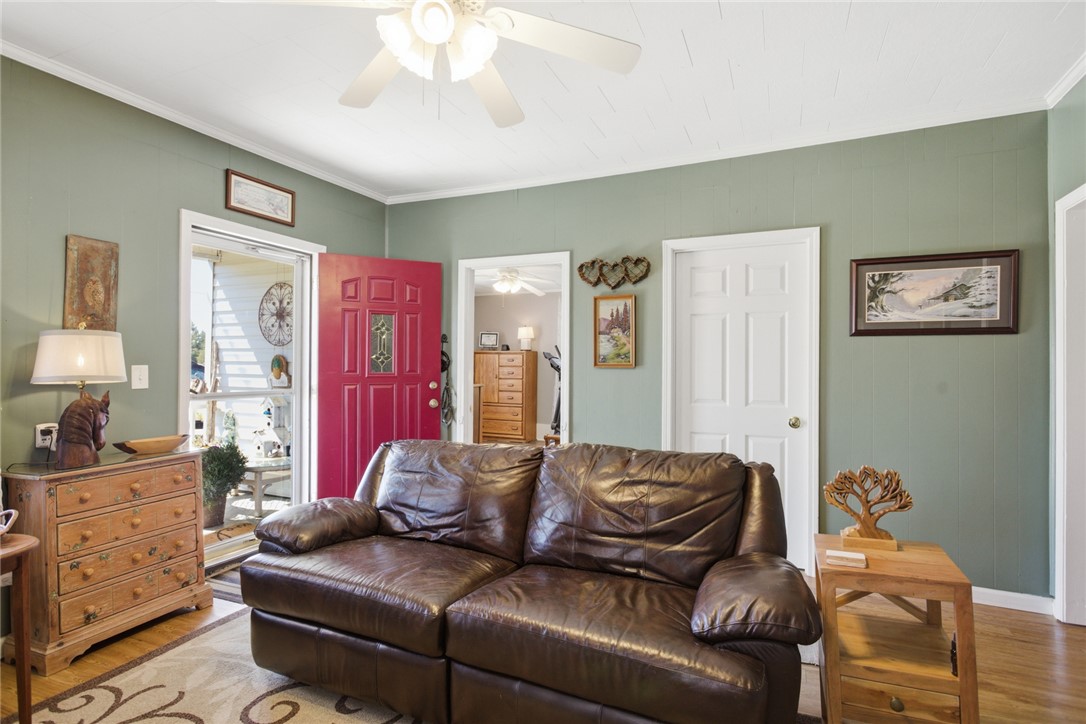 175 Burkett Road Seneca, SC 29672 - Photo 7 of 47 This inviting living space features warm wood flooring and a refreshing ceiling fan.