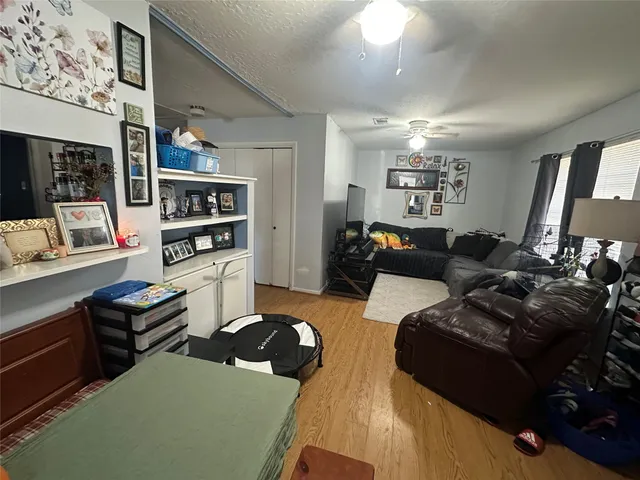 a living room with furniture and a bookshelf