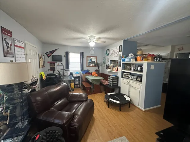 a living room with furniture and a kitchen view
