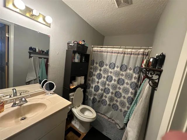 a room with water heater and wooden floor