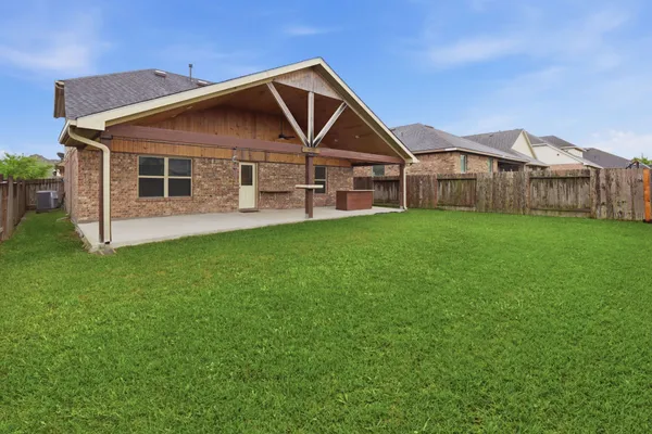 a front view of a house with yard and green space