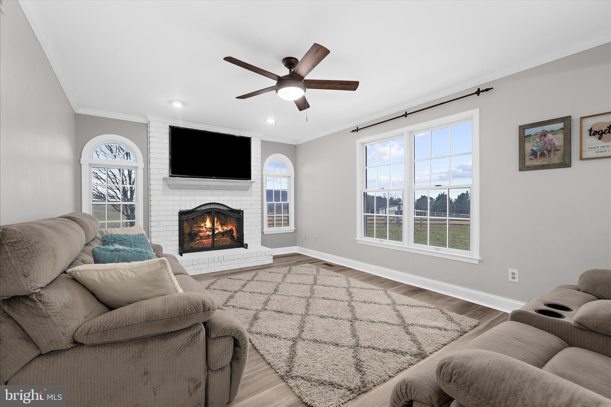 847 Stansbury Road Pylesville, MD 21132 - Photo 6 of 55 Family Room with Fireplace and Ceiling Fan