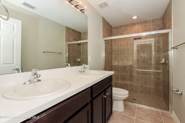a bathroom with a sink shower and a toilet