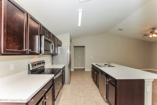 a kitchen with a stove and a refrigerator