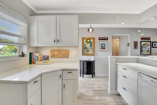 a kitchen with cabinets and window