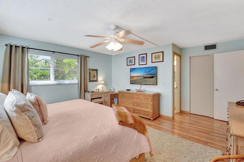 2615 Northeast 3rd Street, Unit 301 Boynton Beach, FL 33435 - Photo 21 of 67 a bedroom with a bed and wooden floor