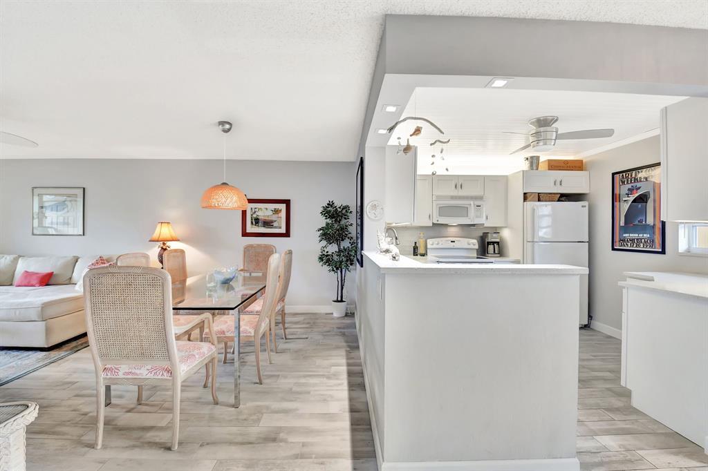 2615 Northeast 3rd Street, Unit 301 Boynton Beach, FL 33435 - Photo 6 of 67 a living room with furniture a dining table and chairs