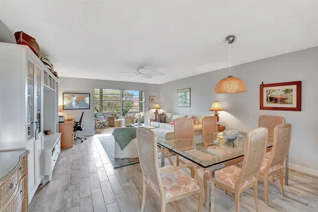 a living room with furniture large window and flat screen tv