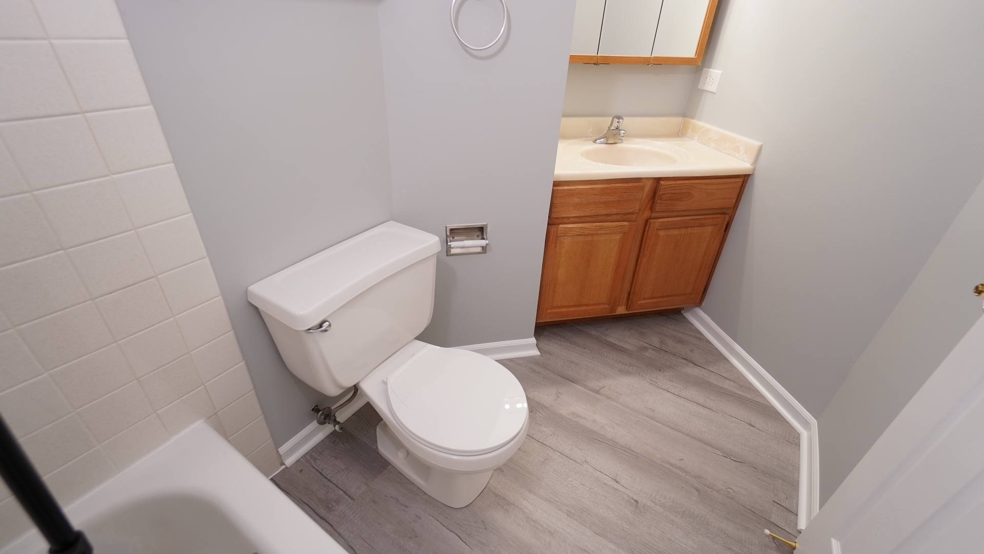 123 West Willowbrook Court, Unit 3 Schaumburg, IL 60195 - Photo 18 of 25 a white toilet sitting next to a bathroom sink