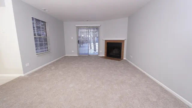 a view of empty room with a fireplace