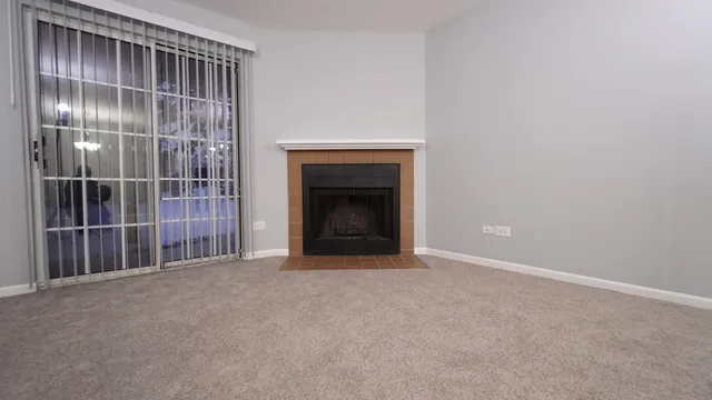 a view of an empty room with a fireplace