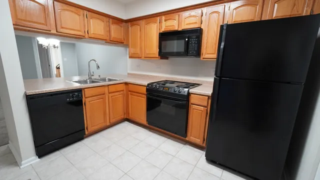 a kitchen with stainless steel appliances granite countertop a refrigerator stove and sink