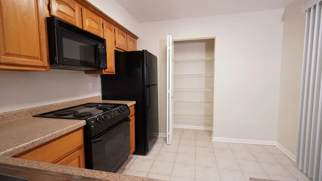 a kitchen with stainless steel appliances granite countertop a stove microwave and refrigerator