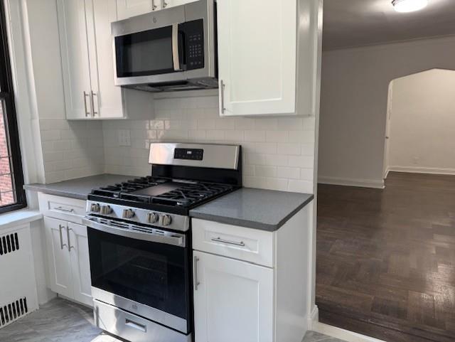 2515 Glenwood Road, Unit 2E Brooklyn, NY 11210 - Photo 3 of 9 a kitchen with a stove and a microwave