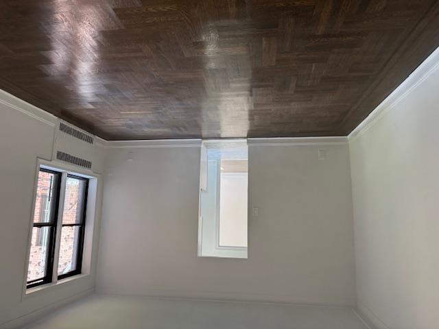 2515 Glenwood Road, Unit 2E Brooklyn, NY 11210 - Photo 5 of 9 an empty room with wooden floor and windows
