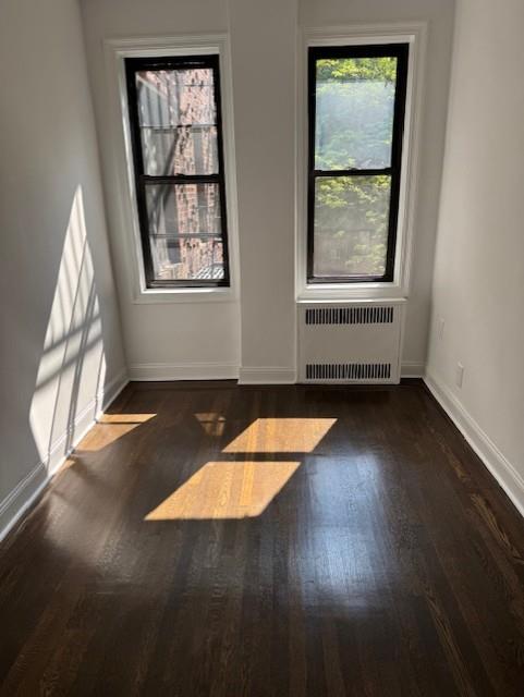 2515 Glenwood Road, Unit 2E Brooklyn, NY 11210 - Photo 6 of 9 an empty room with wooden floor and windows