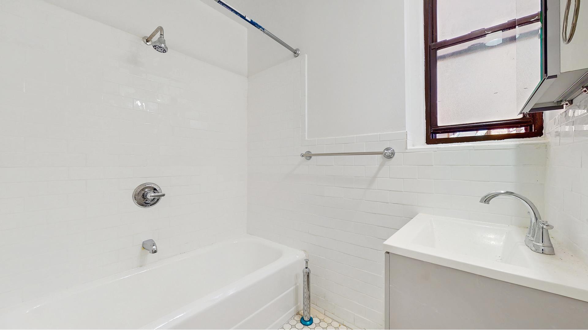 2515 Glenwood Road, Unit 2E Brooklyn, NY 11210 - Photo 7 of 9 a bathroom with a sink and a bathtub