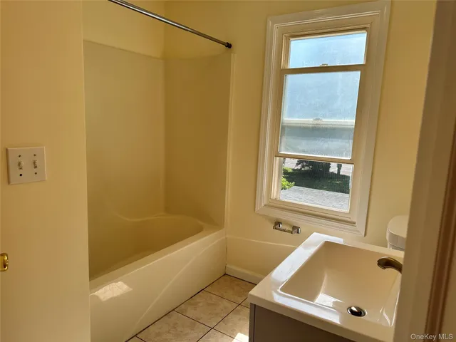 a bath tub sitting next to a shower