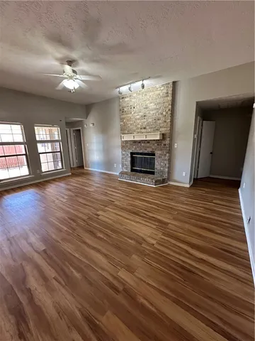 wooden floor in an empty room with a fireplace
