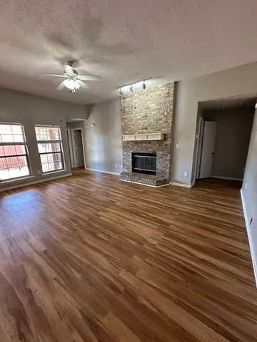 wooden floor in an empty room with a fireplace