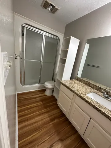 a bathroom with a toilet and a shower