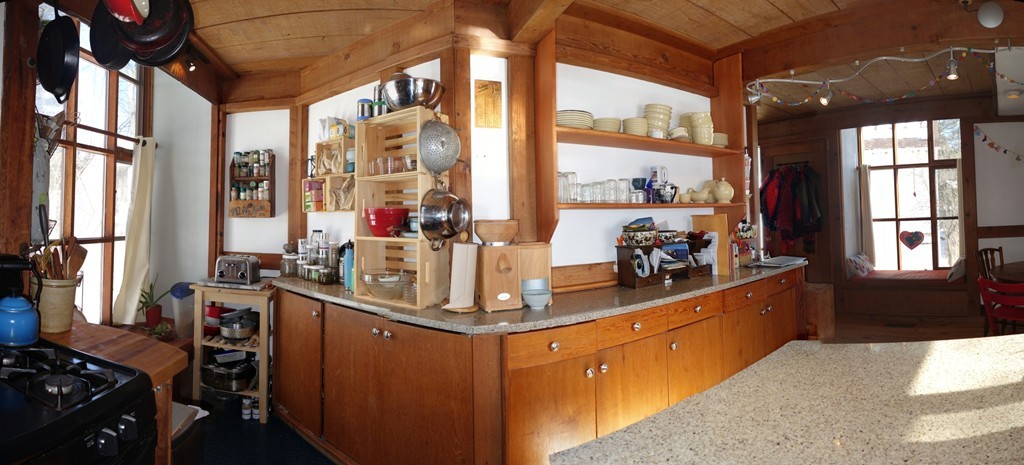 53 Pine Grove, Unit 53 Amherst, MA 01002 - Photo 7 of 24 a kitchen with stainless steel appliances kitchen island granite countertop a stove and a dining table next to a window