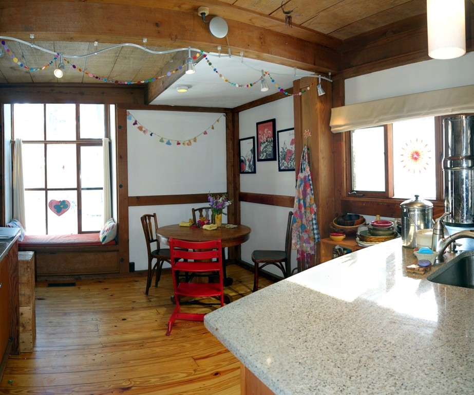 53 Pine Grove, Unit 53 Amherst, MA 01002 - Photo 9 of 24 a view of a dining room with furniture window and wooden floor