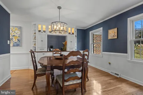 a view of a dining room with furniture and chandelier