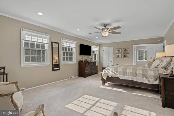 a bedroom that has a bed and chair in it