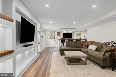 a kitchen with stainless steel appliances kitchen island granite countertop a refrigerator and a stove top oven