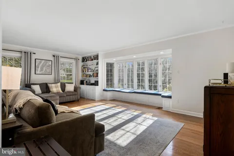 a living room with furniture and large windows
