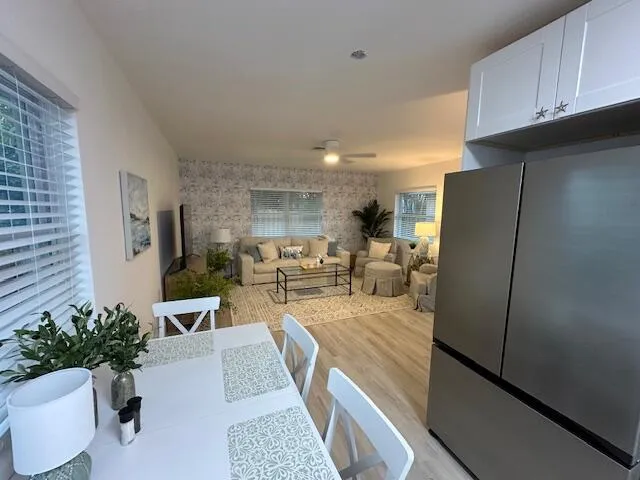 a kitchen with kitchen island a counter top space cabinets stainless steel appliances and a window