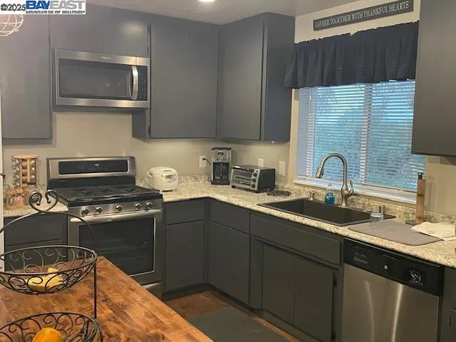 a kitchen with a sink stove and microwave