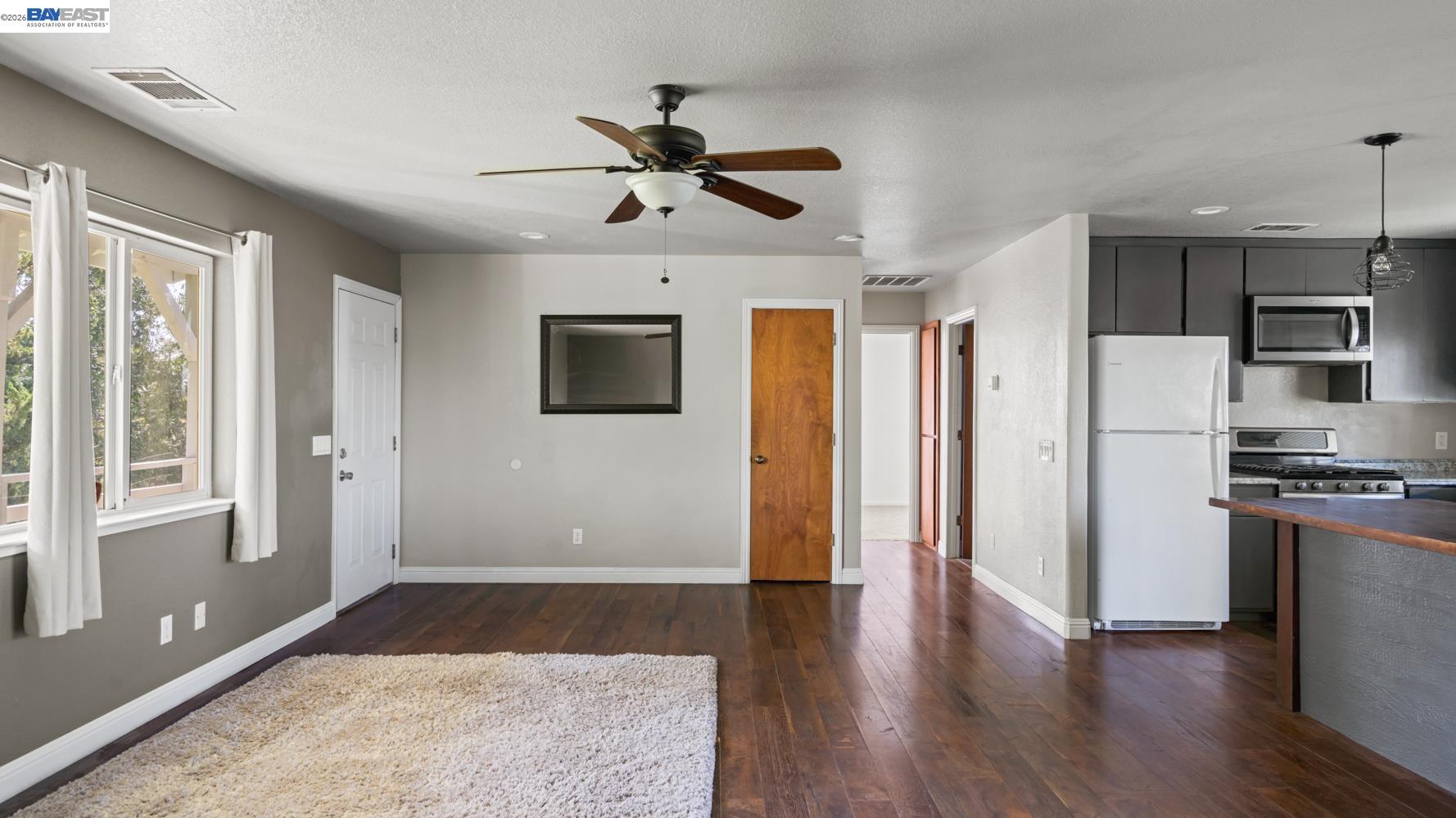 3710 Lakeview Drive Shingle Springs, CA 95682 - Photo 7 of 49 a view of a livingroom with a flat screen tv wooden floor and a ceiling fan