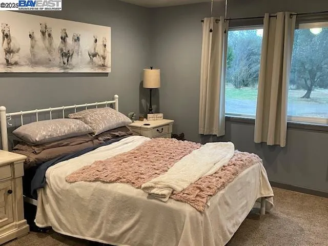 a bedroom with a bed and glass window