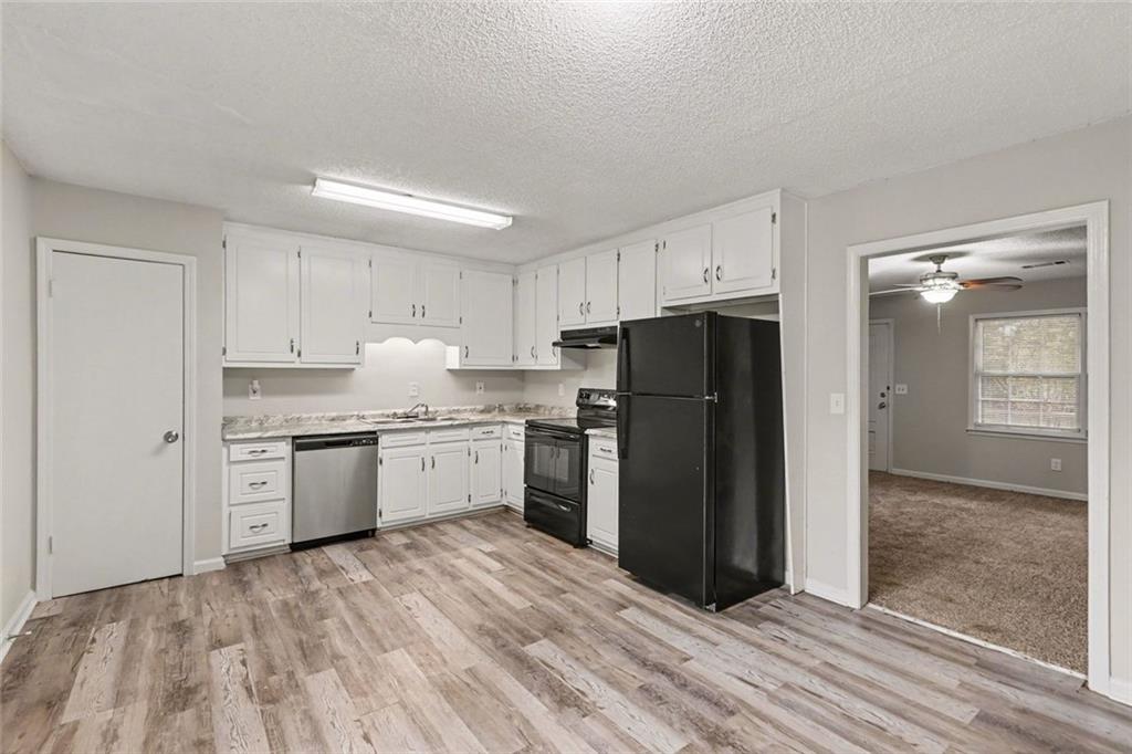 4500 Nebo Road Hiram, GA 30141 - Photo 3 of 15 a kitchen with a refrigerator sink and cabinets