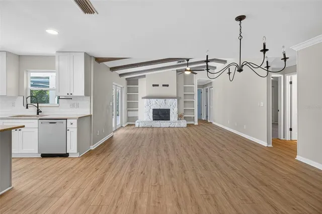 a view of a kitchen with a sink cabinets and wooden floor