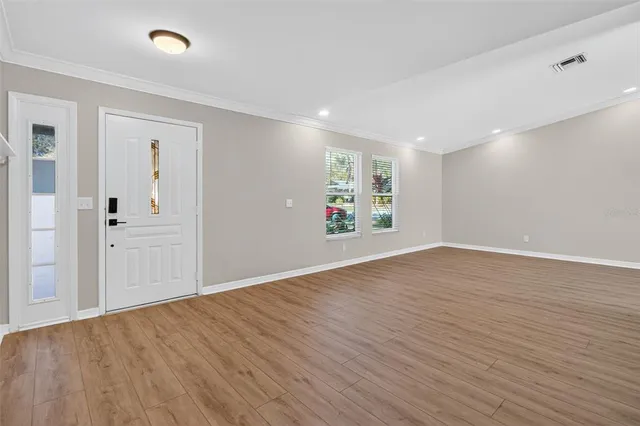 wooden floor in an empty room with a window