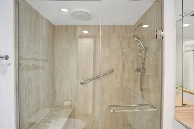 a bathroom with a sink vanity granite tub and a mirror