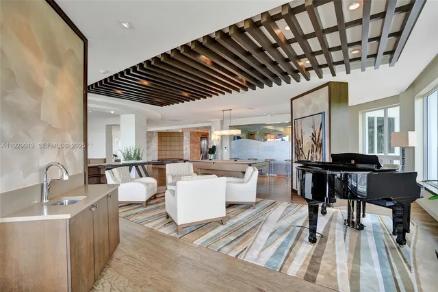 a view of a dining room with furniture and a book shelf