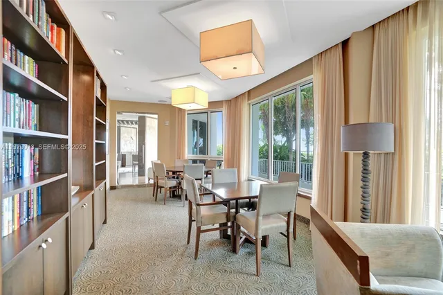 a view of a swimming pool with outdoor seating and plants