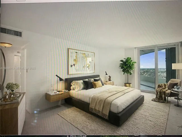 a bedroom with a bed couch and a window