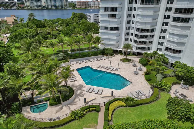a front view of a house with a yard and potted plants