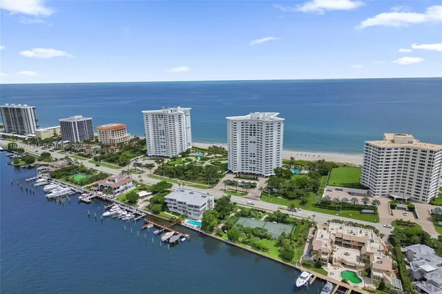 an aerial view of a house with a garden and lake view