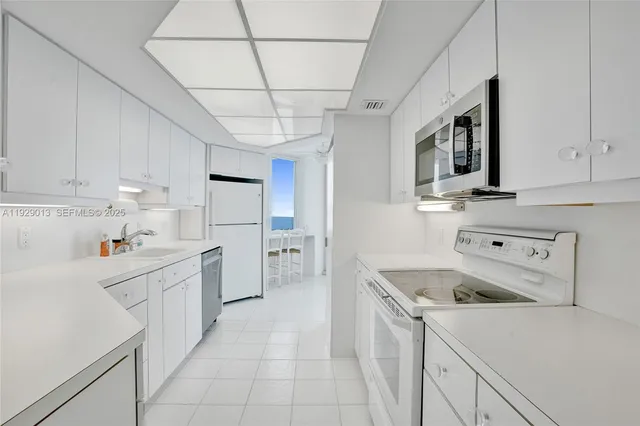 a view of an entryway with chandelier and bathroom