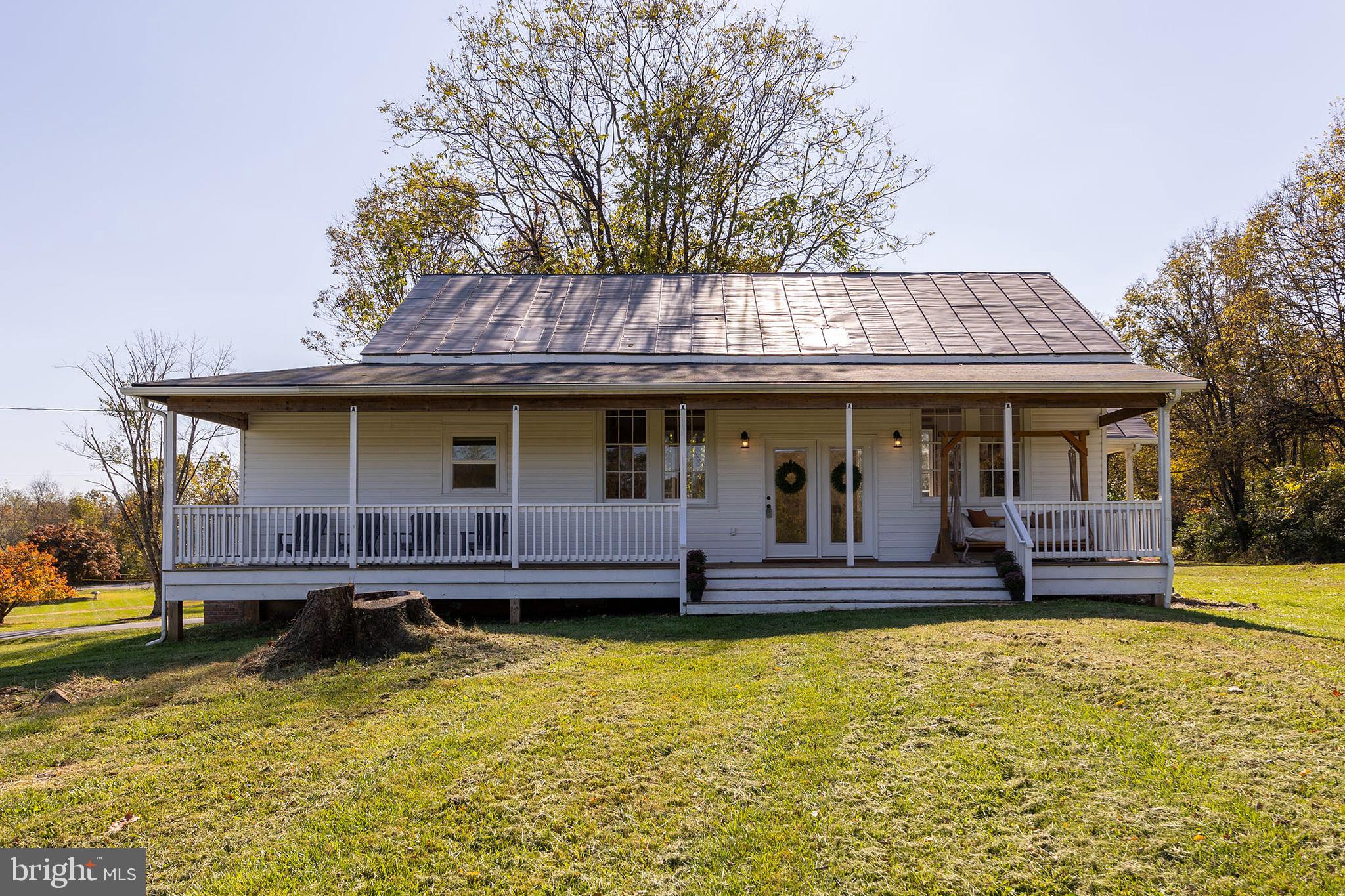 a view of house with swimming pool in front of it