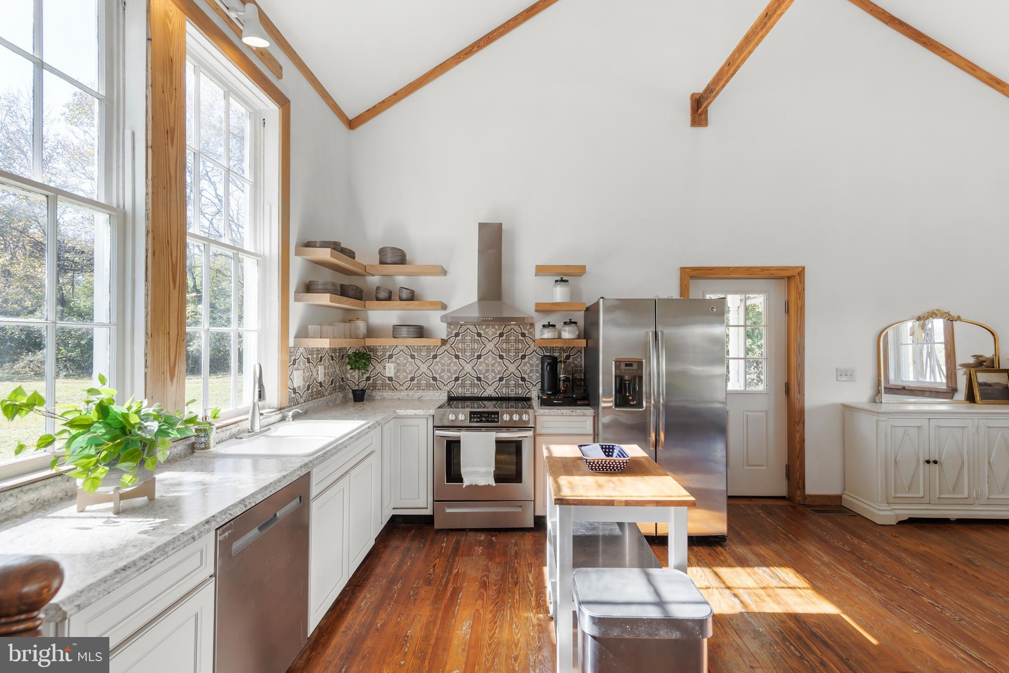 571 Rest Church Road Winchester, VA 22603 - Photo 10 of 45 a kitchen with stainless steel appliances granite countertop a stove a sink and a refrigerator