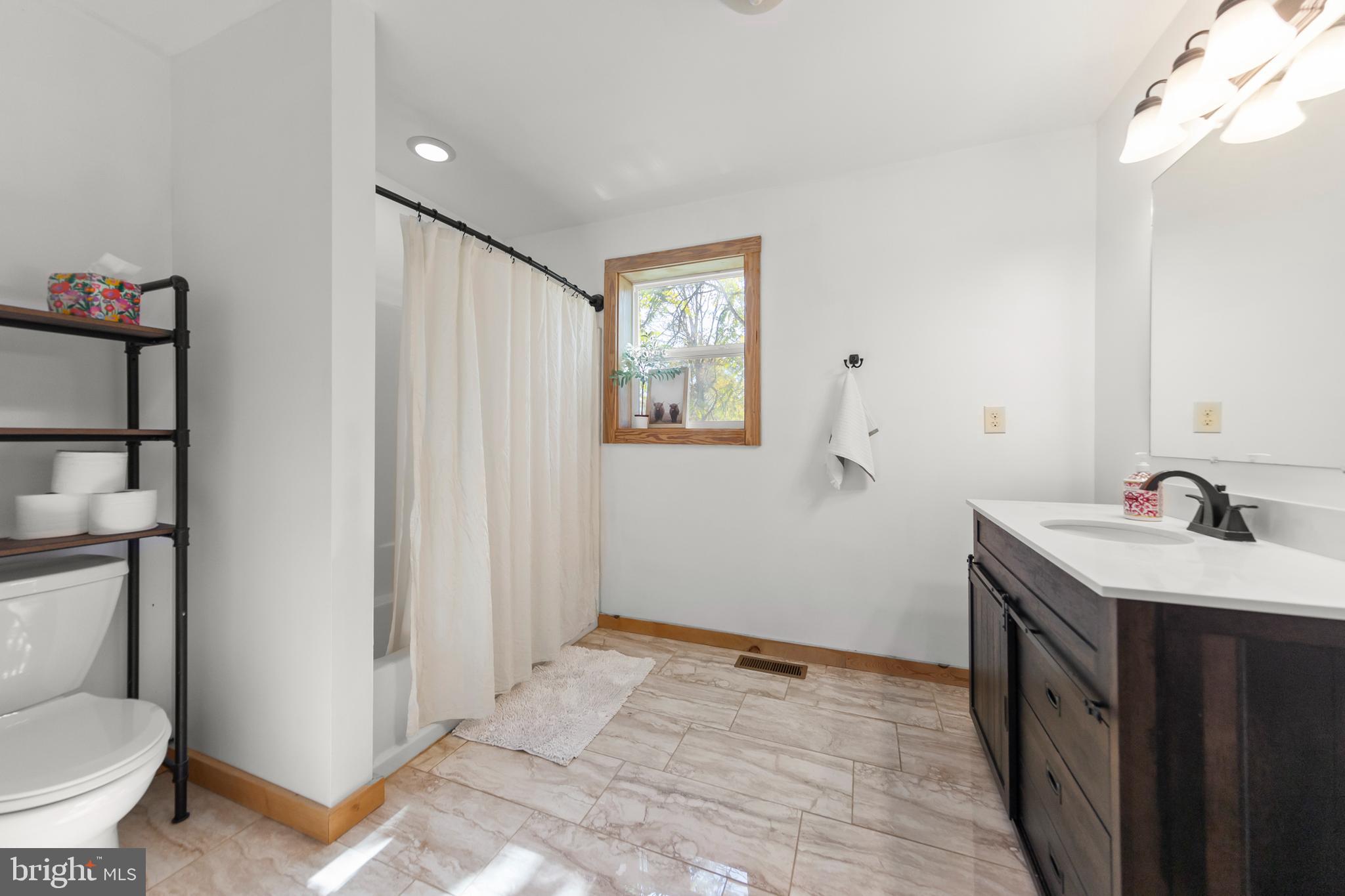 571 Rest Church Road Winchester, VA 22603 - Photo 22 of 45 a bathroom with a toilet sink and mirror